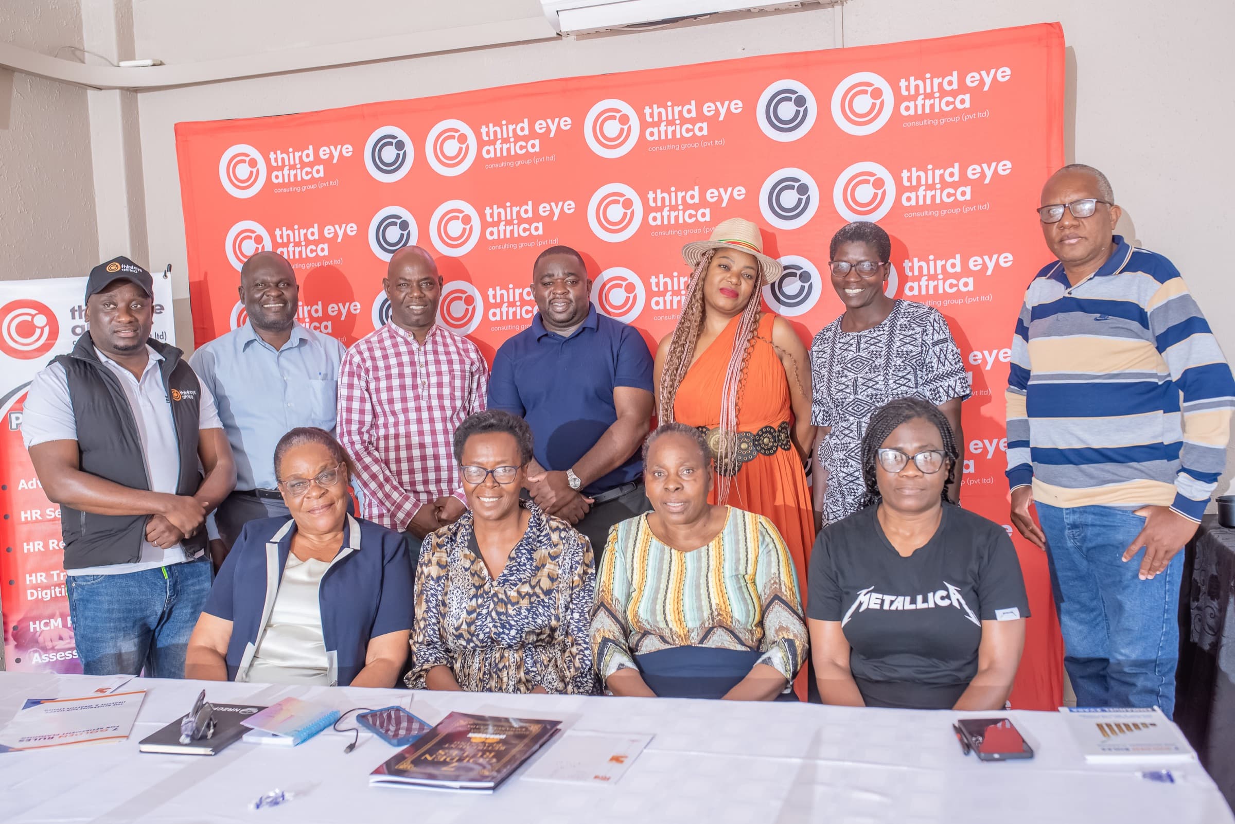 A training cohort posing together in front of a 3rd Eye Africa backdrop